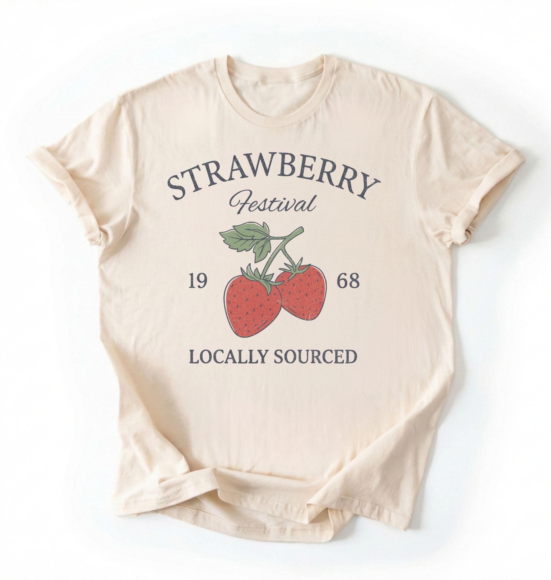Flat lay of a Vintage strawberry festival graphic shirt with locally sourced design on ivory tee on a white background 