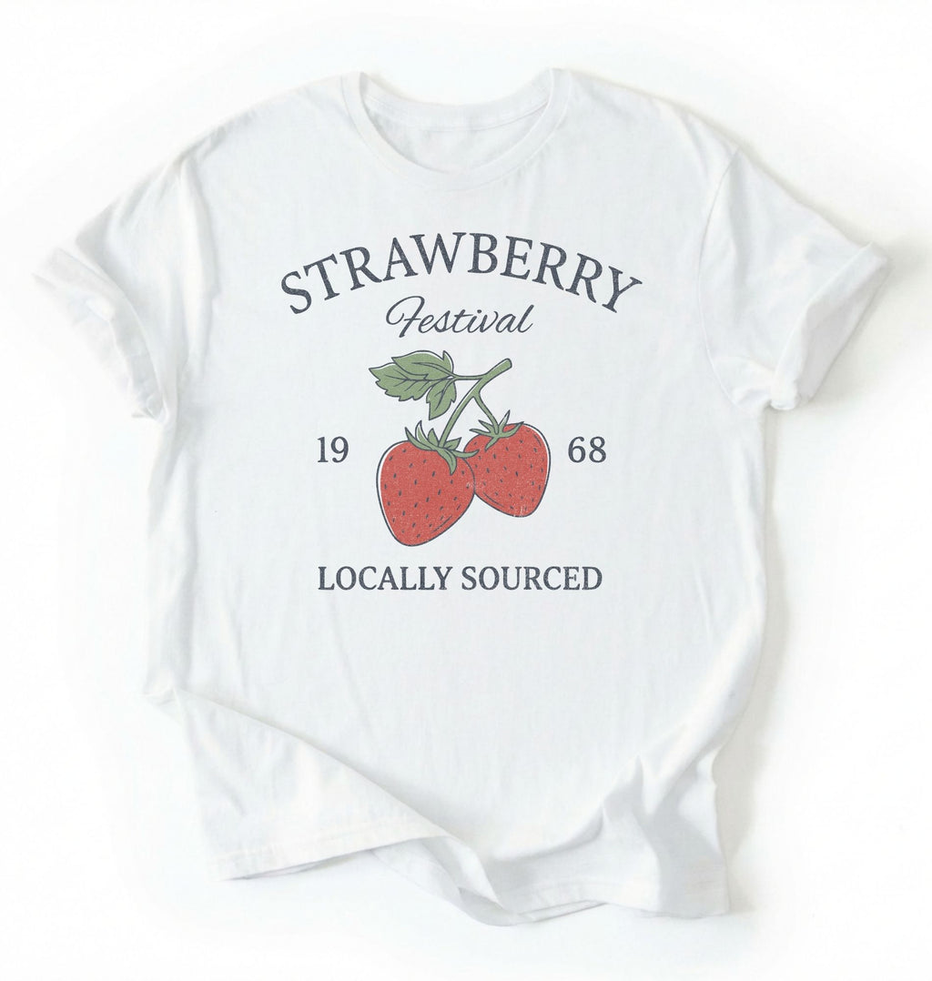 Flat lay of a Vintage strawberry festival graphic shirt with locally sourced design on white tee on a white background 