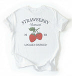 Flat lay of a Vintage strawberry festival graphic shirt with locally sourced design on white tee on a white background 