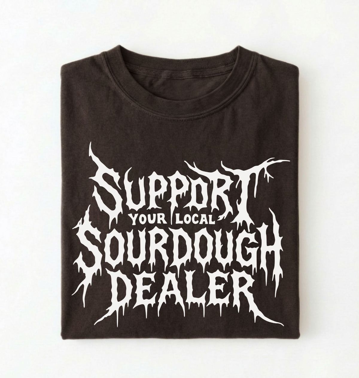 A folded black t-shirt with a white graphic print that reads 'SUPPORT YOUR LOCAL SOURDOUGH DEALER' in a stylized, dripping font, displayed against a plain white background.