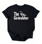 Flat lay of a the gardenfather shirt black funny gardening dad t shirt plant lover gift on a white background 