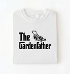 Flat lay of a the gardenfather shirt white funny gardening dad t shirt plant lover gift on a white background 