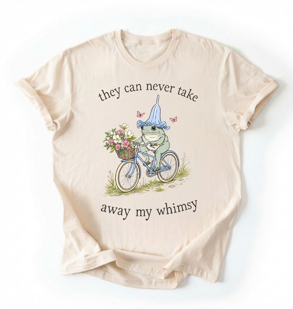 Flat lay of an ivory Cute whimsical frog shirt for nature and cottagecore fashion lovers on a white background 
