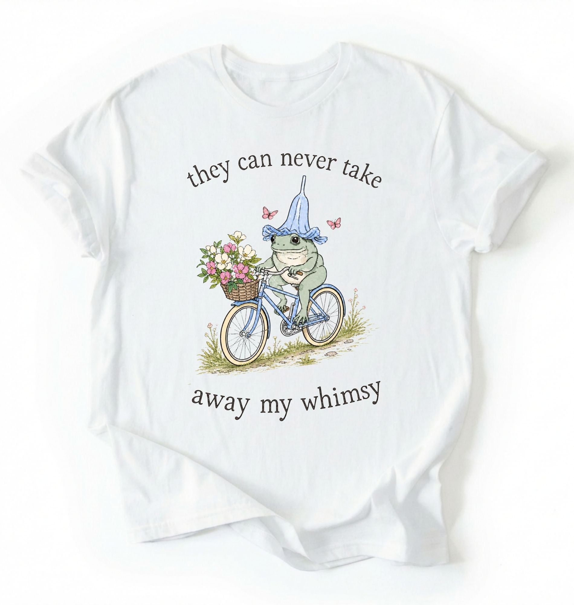 Flat lay of a white Cute whimsical frog shirt for nature and cottagecore fashion lovers on a white background 