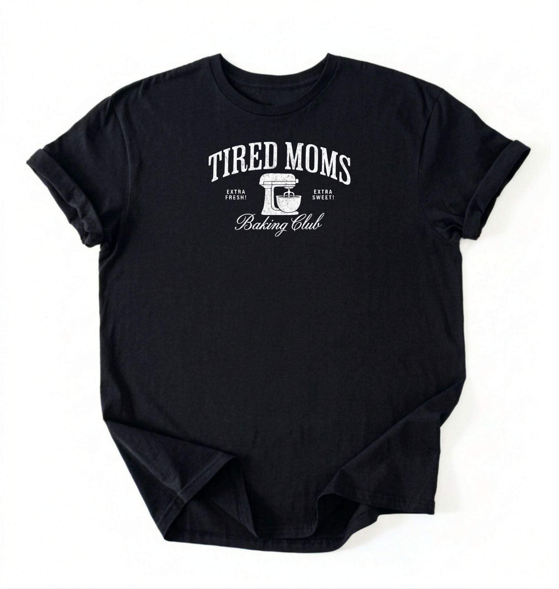 Flat lay of a black Tired Moms Baking Club graphic shirt with stand mixer design for baking moms on a white background 