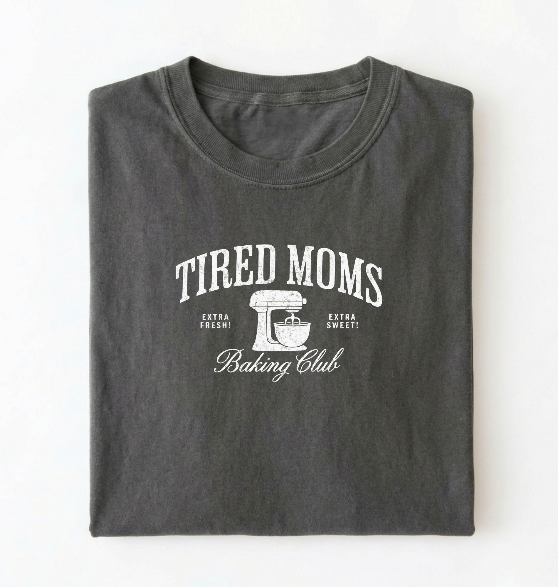 Flat lay of a grey Tired Moms Baking Club graphic shirt with stand mixer design for baking moms on a white background 