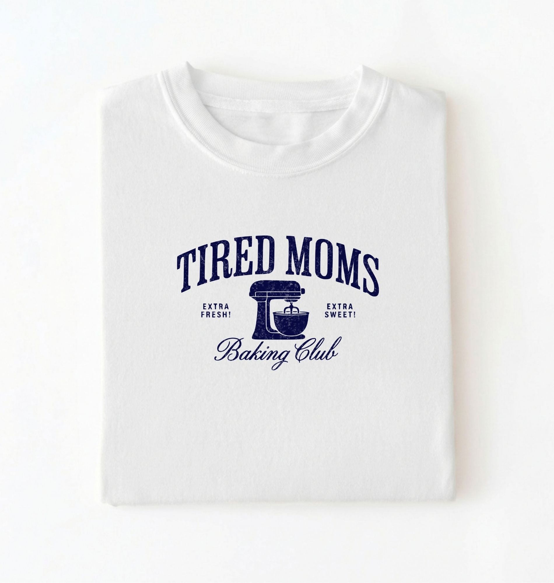 Flat lay of a white Tired Moms Baking Club graphic shirt with stand mixer design for baking moms on a white background 