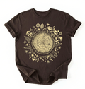 Flat lay of a dark chocolate tree rings shirt with forest and botanical design brown aesthetic nature lover gift t-shirt on a white background 