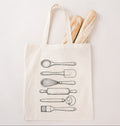 Reusable canvas tote bag for bakers with rolling pin and whisk artwork on a white background
