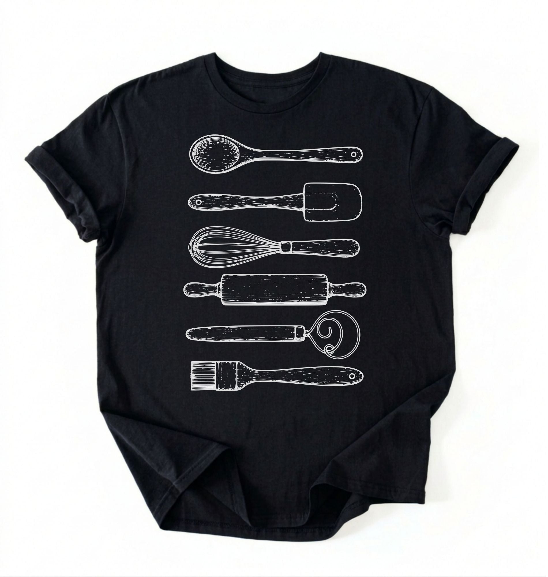 Flat ay of a Vintage baking tools shirt with whisk rolling pin and spatula illustrations on black tee on a white background 