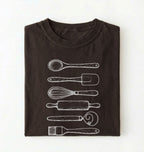 Flat ay of a Vintage baking tools shirt with whisk rolling pin and spatula illustrations on brown tee on a white background 