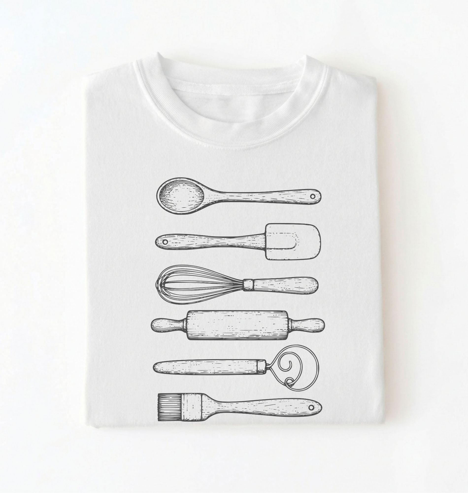 Flat ay of a Vintage baking tools shirt with whisk rolling pin and spatula illustrations on white tee on a white background 