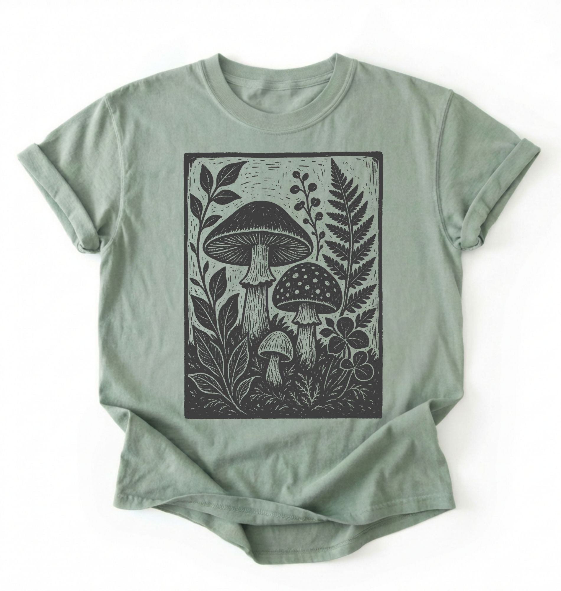 Flat lay of an light green vintage mushroom shirt green botanical fungi t shirt nature lover gift forest aesthetic design on a white background 