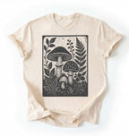 Flat lay of an ivory vintage mushroom shirt green botanical fungi t shirt nature lover gift forest aesthetic design on a white background 