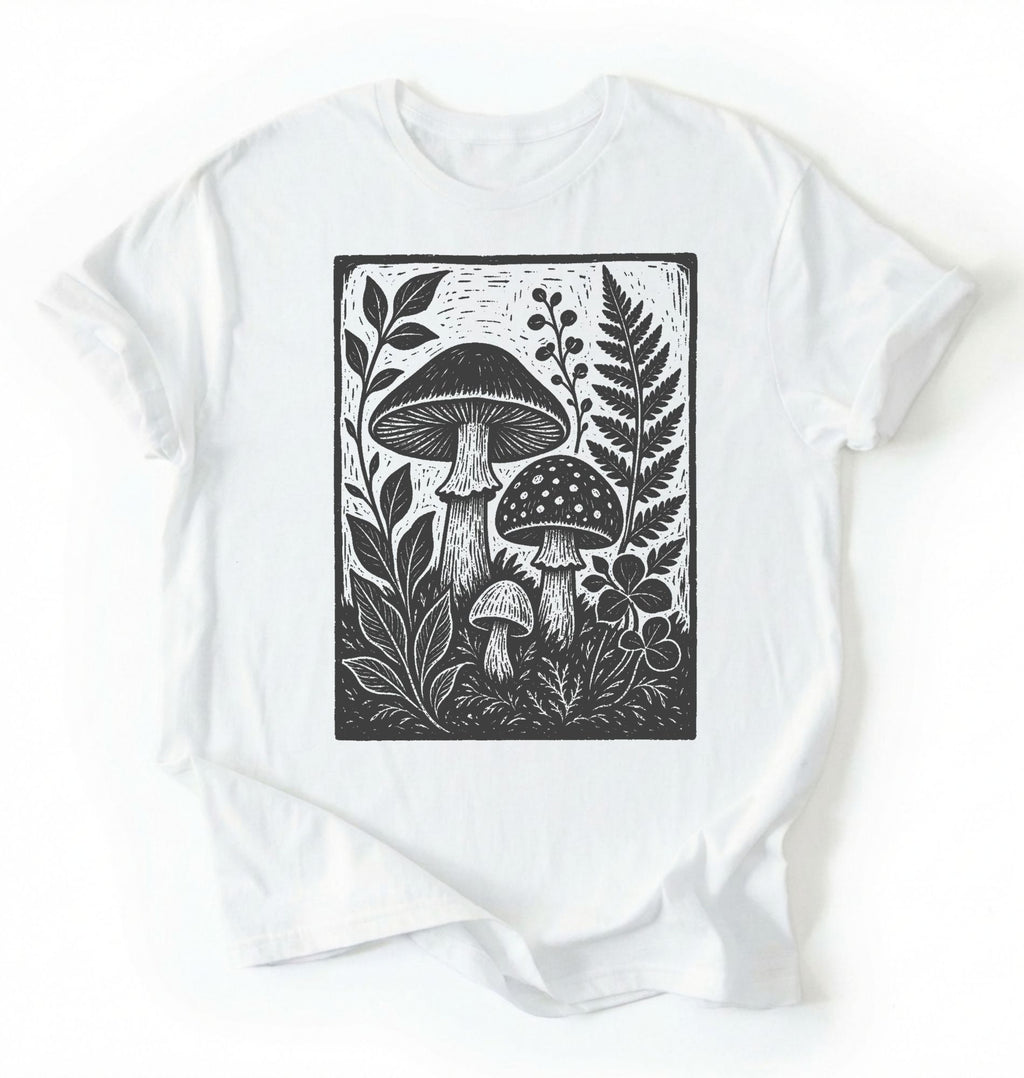 Flat lay of a white vintage mushroom shirt green botanical fungi t shirt nature lover gift forest aesthetic design on a white background 