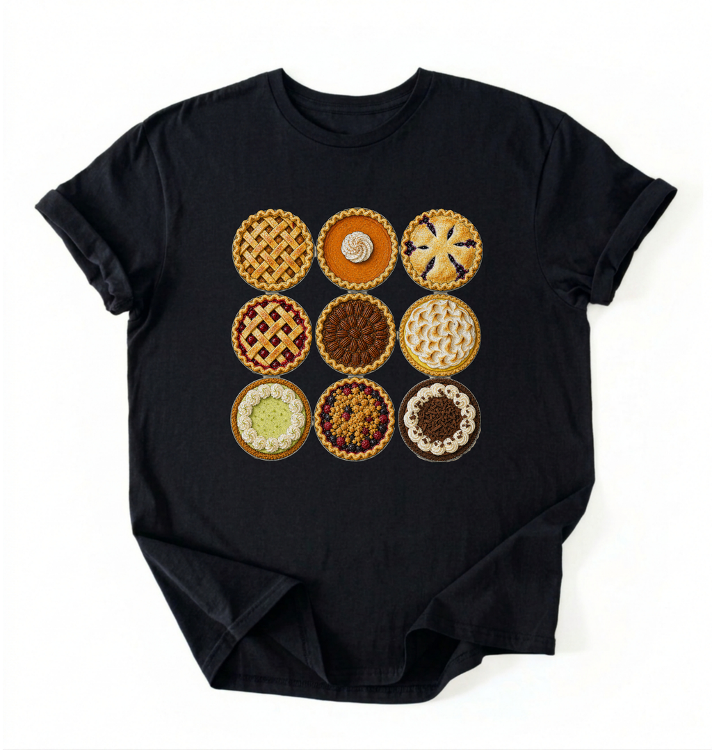 A black short-sleeve crewneck t-shirt featuring a graphic print of a 3x3 grid of various pie and tart designs on the front, displayed flat against a white background.