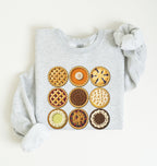 A light gray long-sleeve sweatshirt laid flat on a white background, featuring a graphic print of nine different pies arranged in a 3x3 grid on the front.
