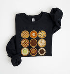 A black long-sleeve sweatshirt with a graphic print of nine different fruit and pastry pies arranged in a 3x3 grid, shown on a plain white background.