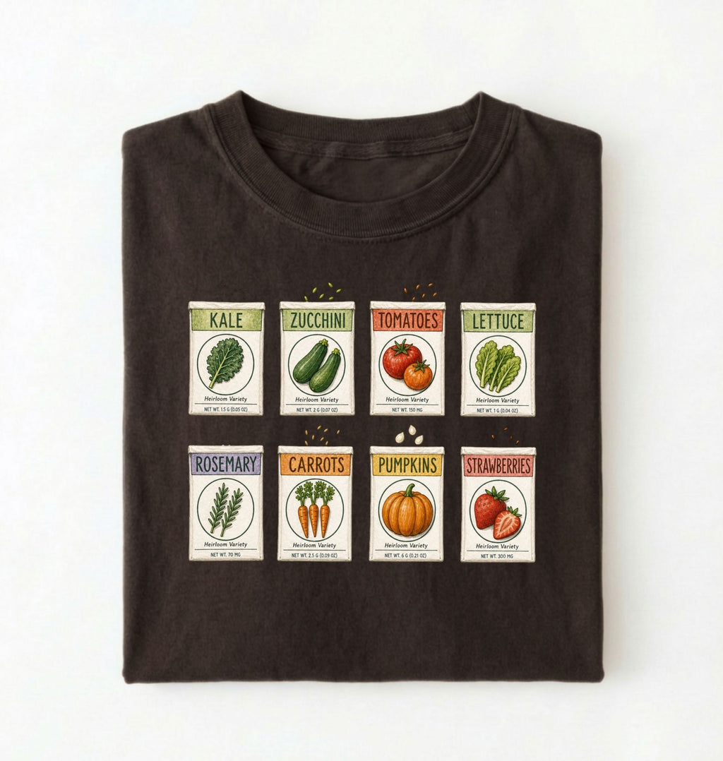 Flat lay of a brown vintage seed packet garden shirt with heirloom vegetable and herb illustrations gardener gift on a white background