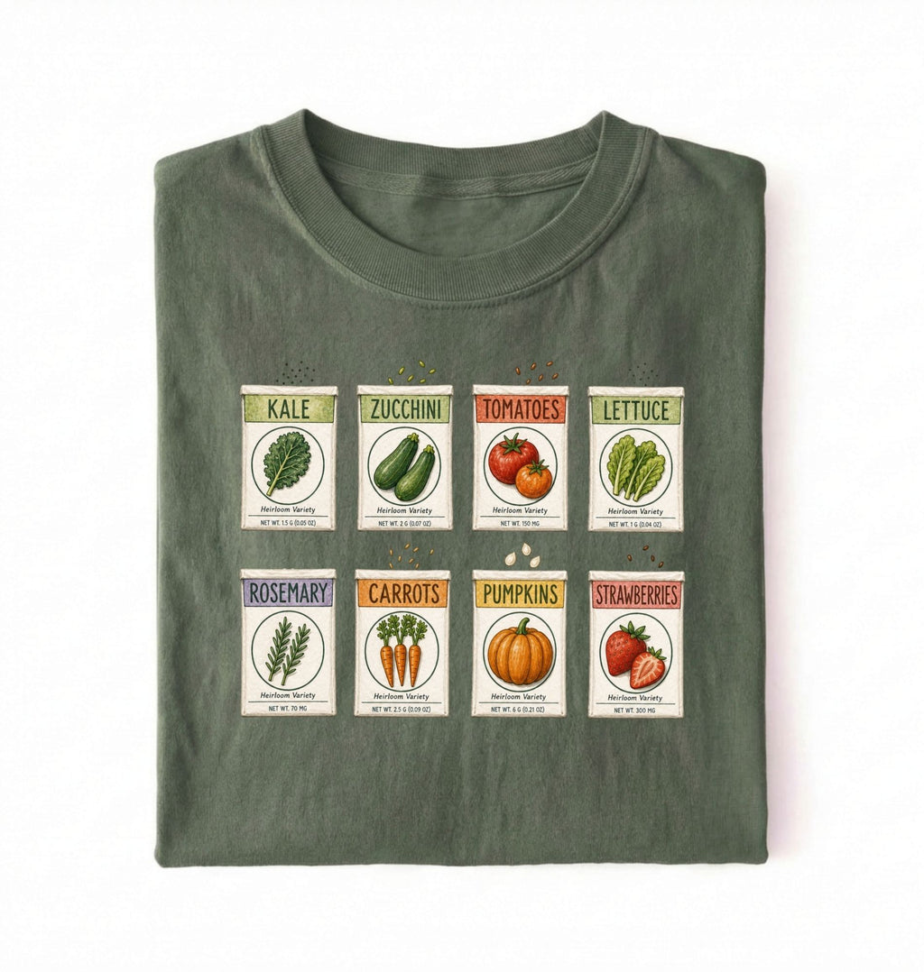 Flat lay of a green vintage seed packet garden shirt with heirloom vegetable and herb illustrations gardener gift on a white background