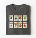 Flat lay of a moss vintage seed packet garden shirt with heirloom vegetable and herb illustrations gardener gift on a white background