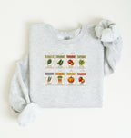 Flat lay of an ash vintage seed packet garden sweatshirt with heirloom vegetable and herb illustrations gardener gift on a white background 