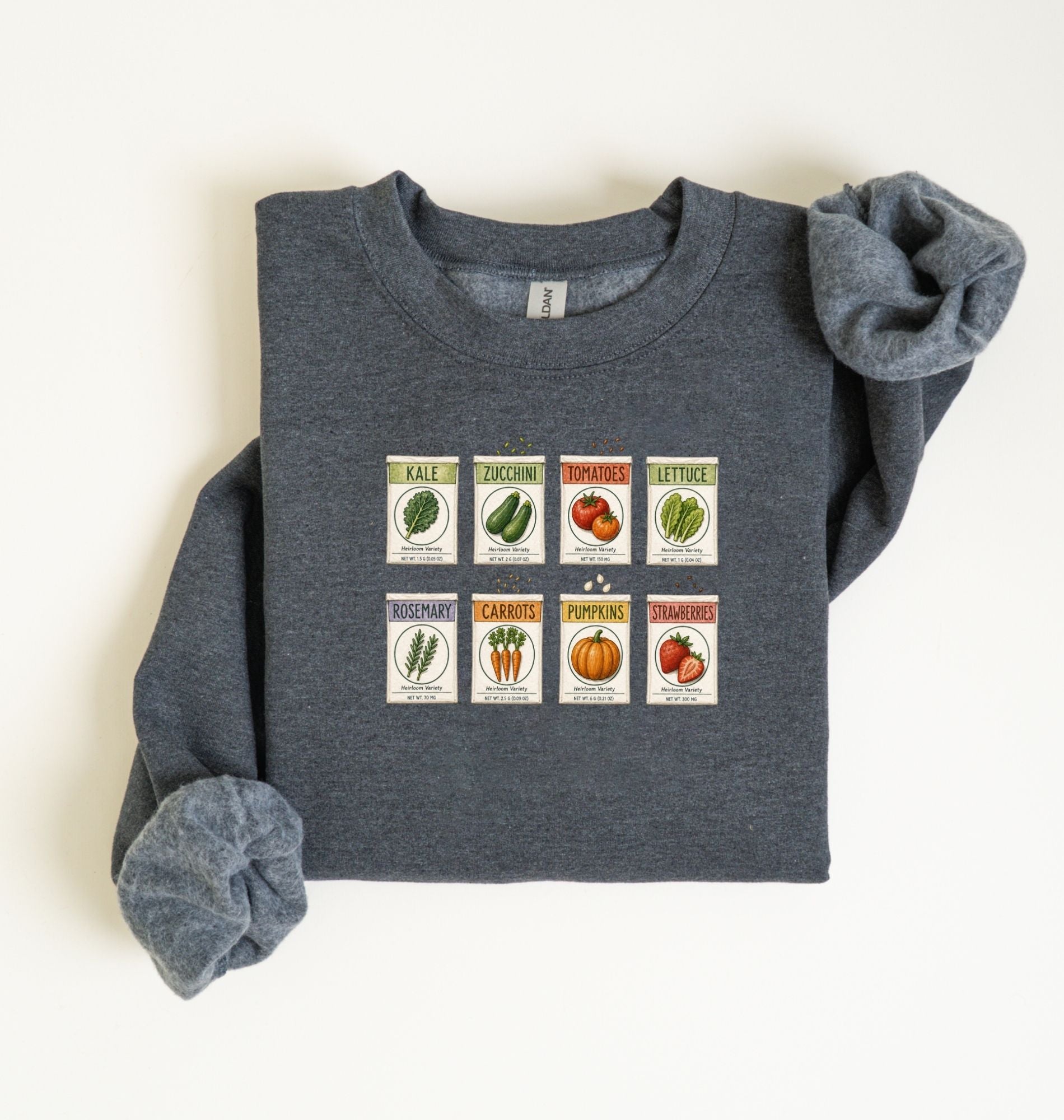Flat lay of an dark heather vintage seed packet garden sweatshirt with heirloom vegetable and herb illustrations gardener gift on a white background 