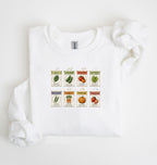 Flat lay of an white vintage seed packet garden sweatshirt with heirloom vegetable and herb illustrations gardener gift on a white background 