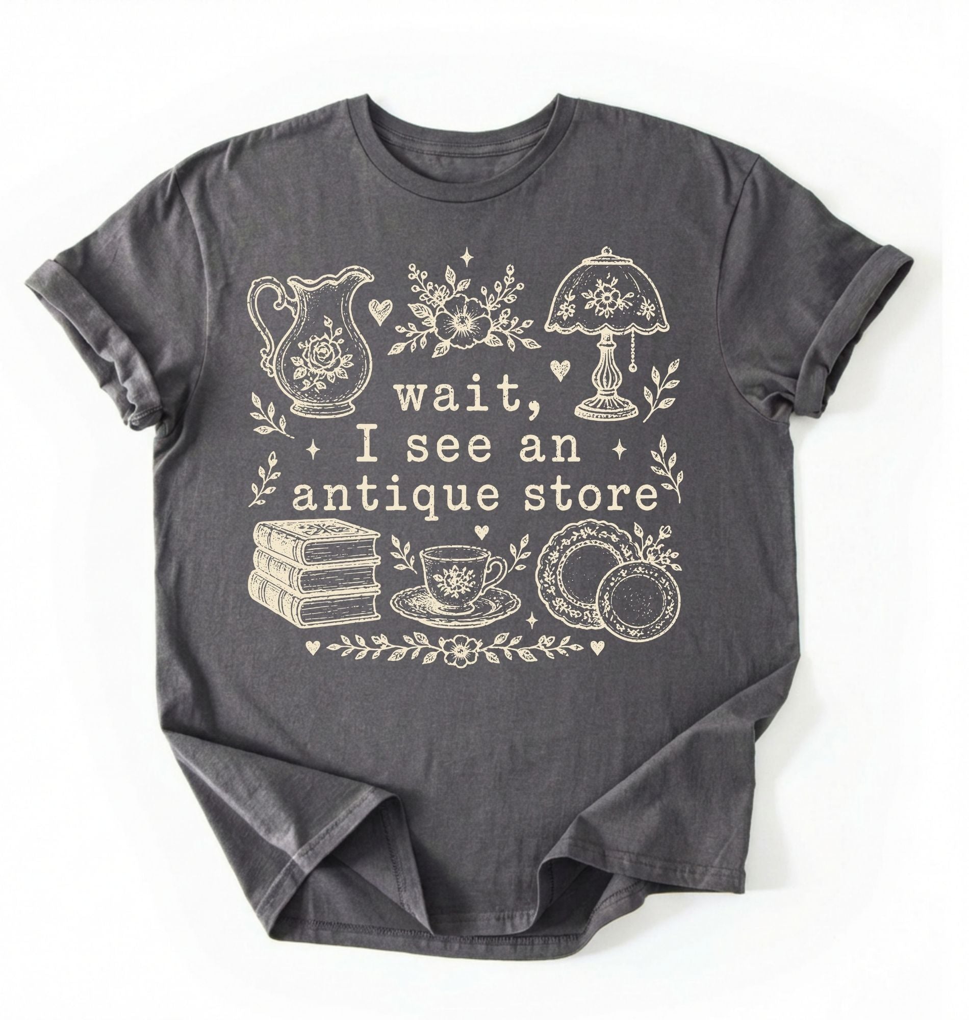 Flat lay of a charcoal wait i see an antique store shirt funny vintage thrift aesthetic gift on a white background 