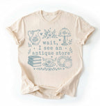 Flat lay of an ivory wait i see an antique store shirt funny vintage thrift aesthetic gift on a white background 