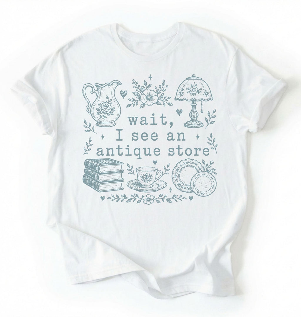 Flat lay of a white wait i see an antique store shirt funny vintage thrift aesthetic gift on a white background 