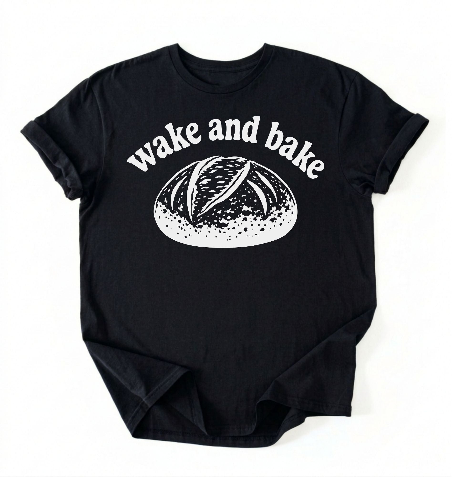 Flat lay of a Funny wake and bake bread shirt with rustic loaf illustration on black tee on a white background