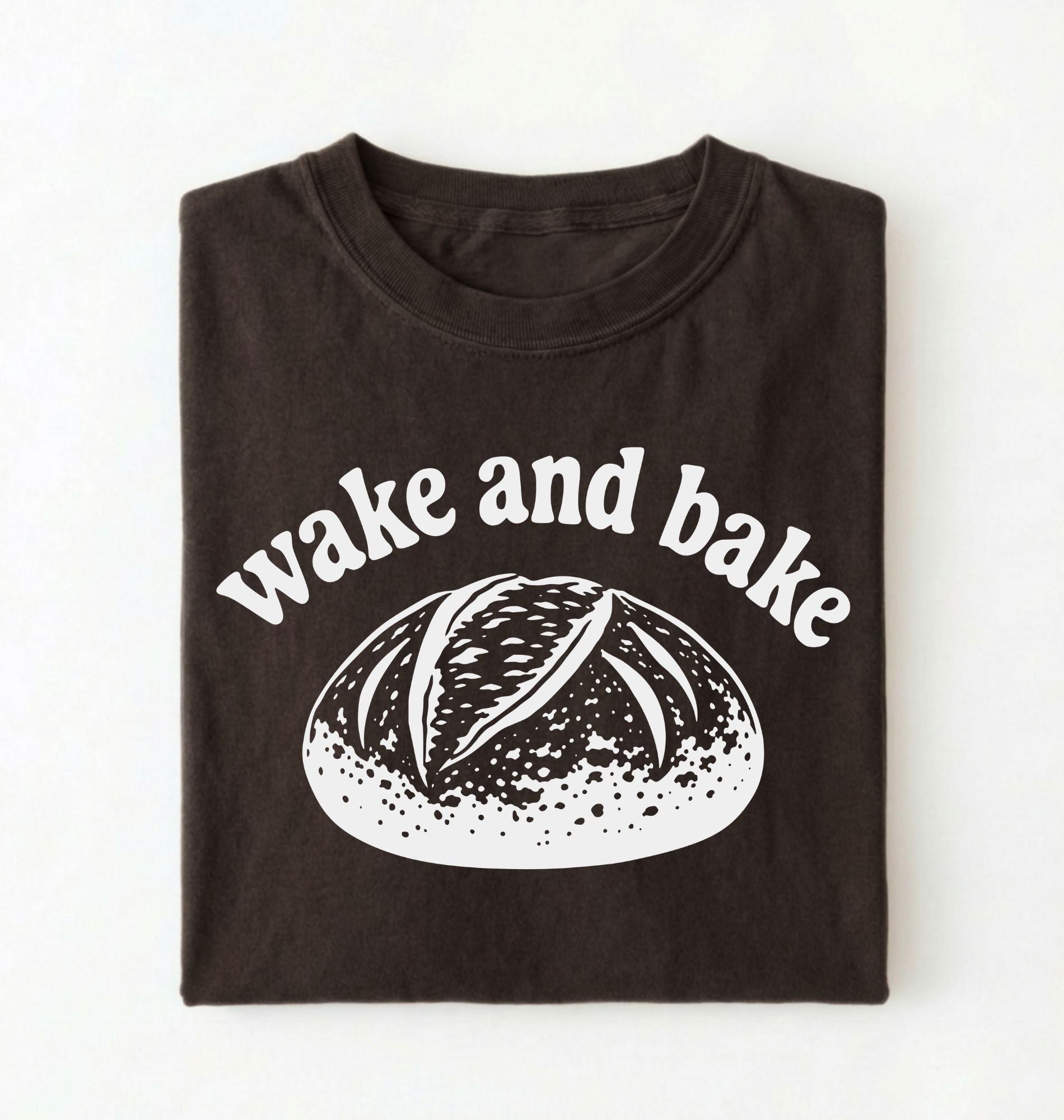 Flat lay of a Funny wake and bake bread shirt with rustic loaf illustration on dark chocolate tee on a white background