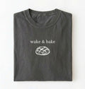 Flat lay of a pepper Funny wake and bake bread shirt perfect for bakers bread lovers and home baking enthusiasts on a white background