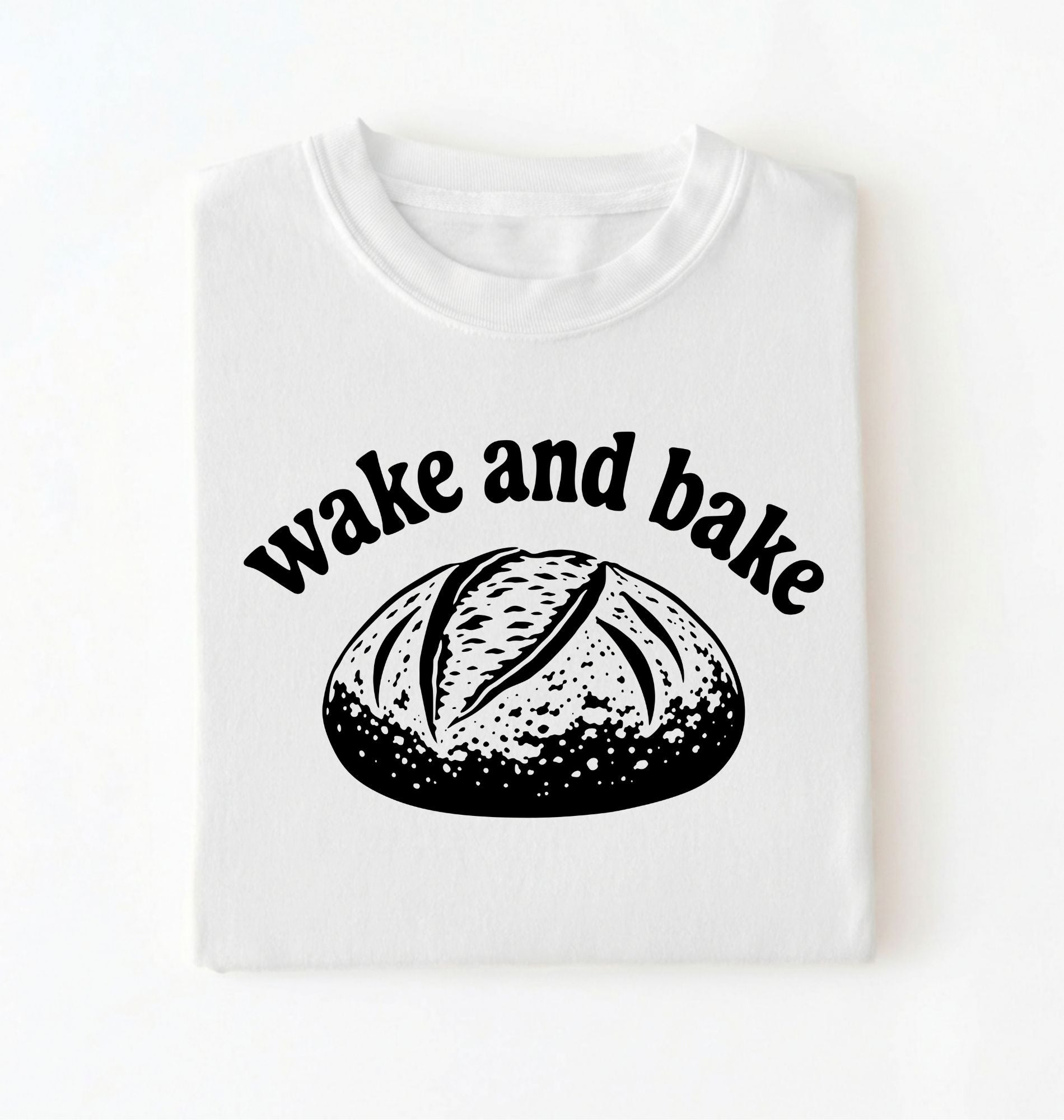 Flat lay of a Funny wake and bake bread shirt with rustic loaf illustration on white tee on a white background