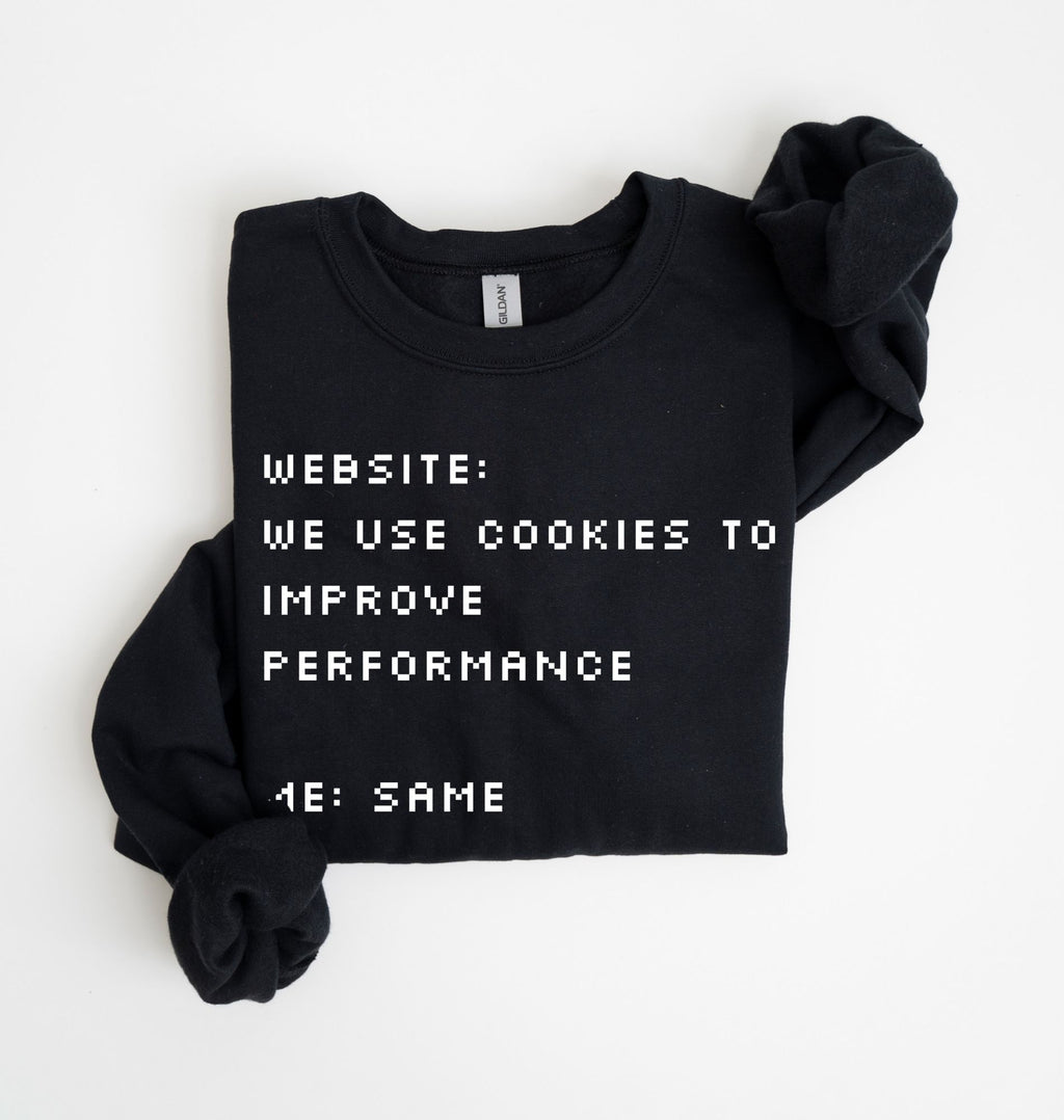 A black crewneck sweatshirt with rolled-up sleeves, featuring white pixelated text that reads 'WEBSITE: WE USE COOKIES TO IMPROVE PERFORMANCE 4E: SAME'.
