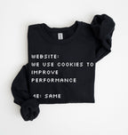 A black crewneck sweatshirt with rolled-up sleeves, featuring white pixelated text that reads 'WEBSITE: WE USE COOKIES TO IMPROVE PERFORMANCE 4E: SAME'.
