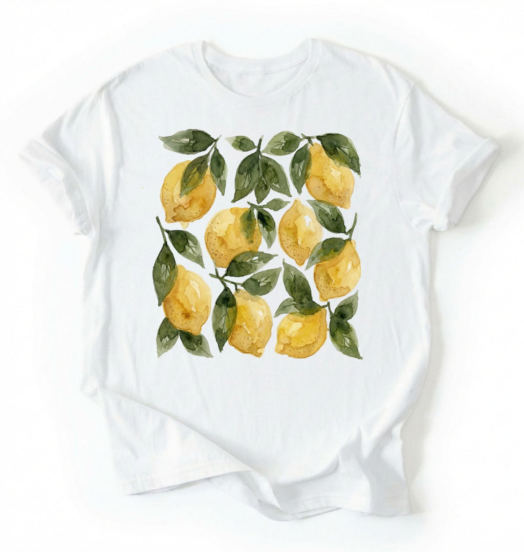 Flat lay White t-shirt with watercolor lemon and green leaf pattern, cottagecore style gardener gift tee on a white background