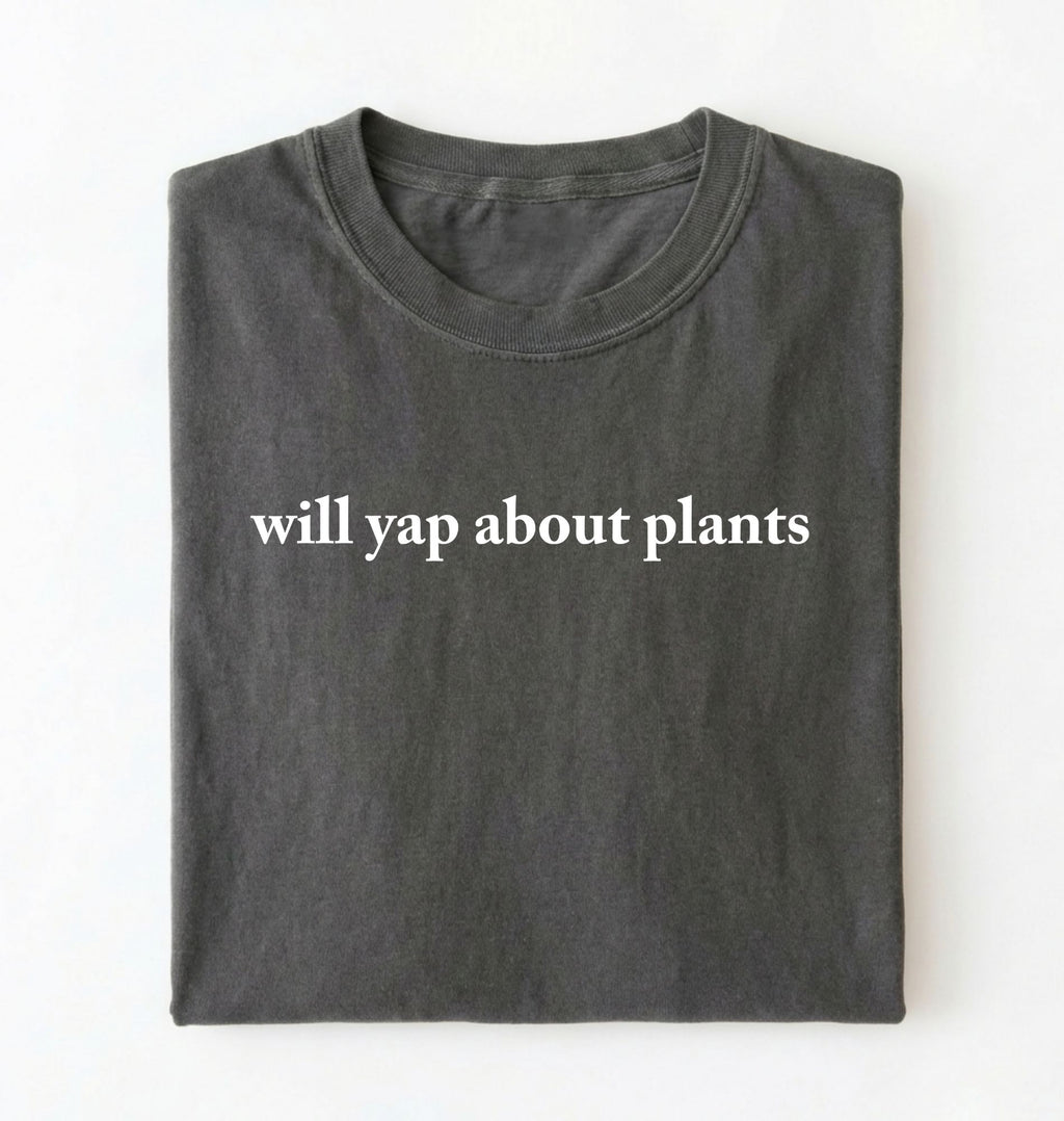 Flat lay of a pepper cozy crewneck t-shirt on a white background with text reading “Will yap about plants centered on the front 