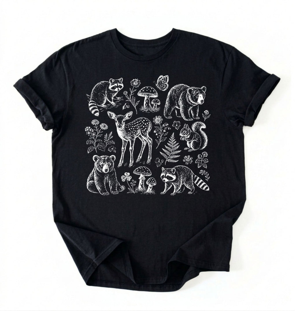 Flat lay of a woodland animals shirt black cottagecore forest animal t shirt mushroom nature gift on a white background 