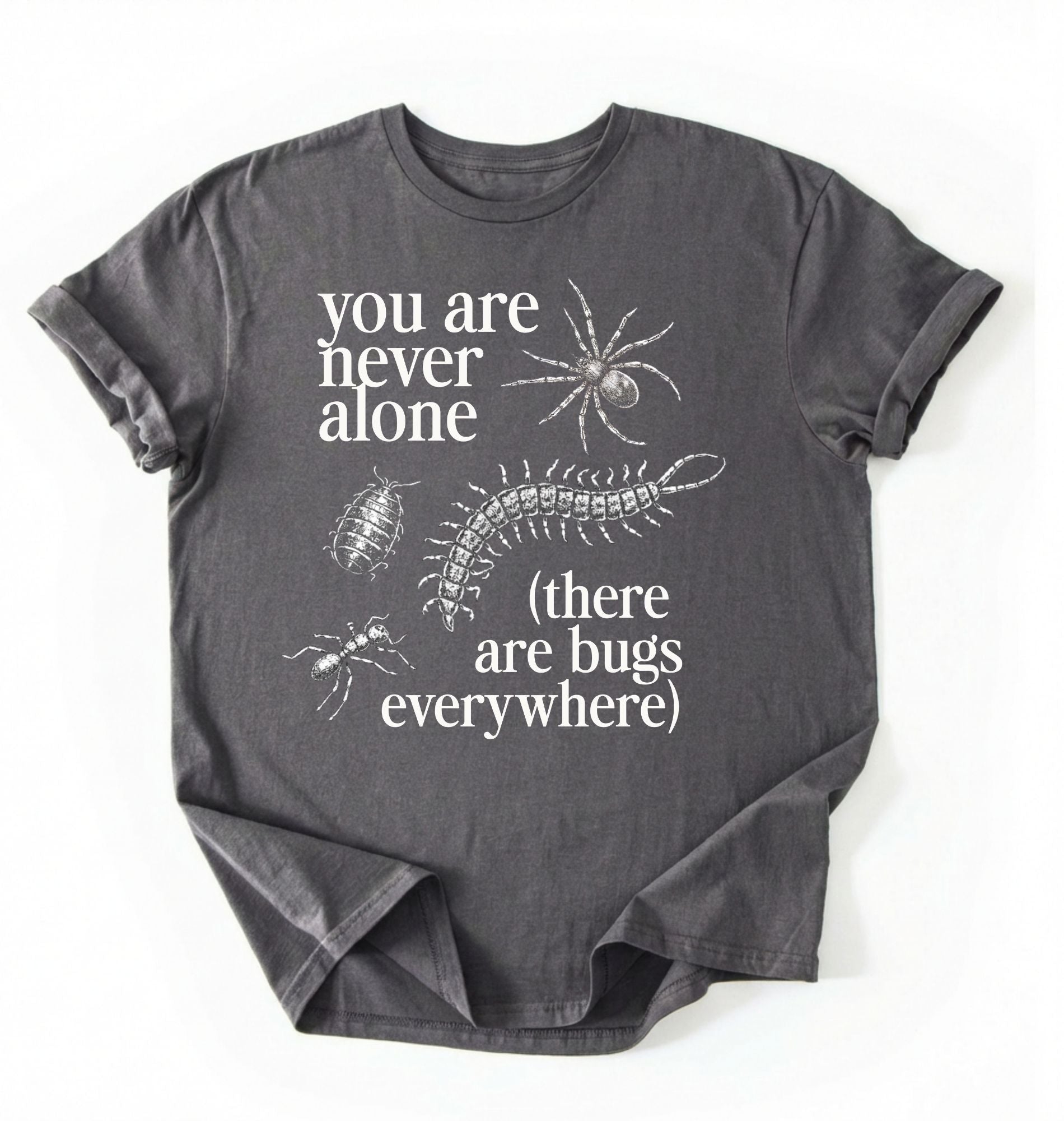 Flat lay of a Charcoal t-shirt featuring illustrated insects including a spider and centipede with text reading “You Are Never Alone (there are bugs everywhere). Funny bug shirt insect illustrations design perfect gift for science lovers 