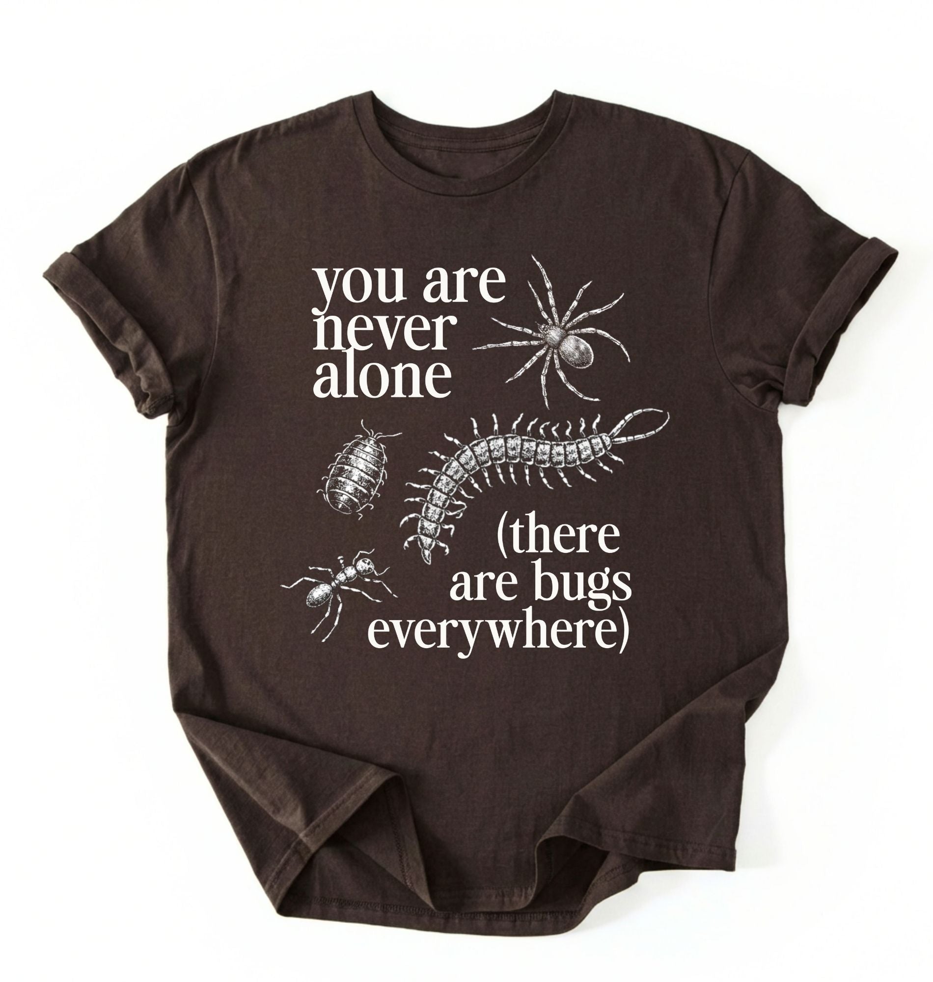 Flat lay of a darkchocolate t-shirt featuring illustrated insects including a spider and centipede with text reading “You Are Never Alone (there are bugs everywhere). Funny bug shirt insect illustrations design perfect gift for science lovers 